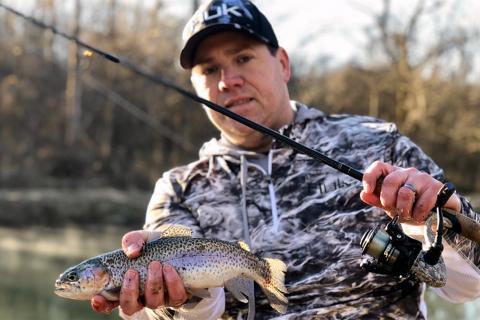 Trout angler proudly holds up his catch