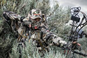 A bow hunter in camo clothing