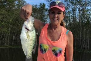Women standing with a large white crappie from Lake Conroe