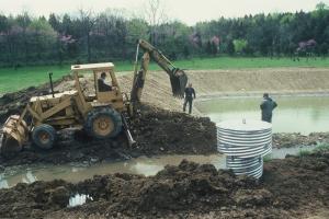 Men digging a farm pond