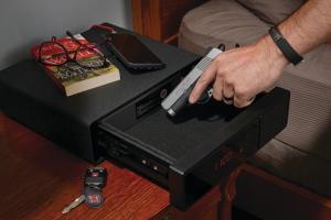 Placing gun into a bedside handgun vault