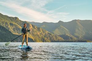 Woman Paddle Boarding on a lake