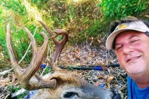 Florida deer hunter posing with his harvested buck