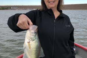Lady angler holding up her First Fish