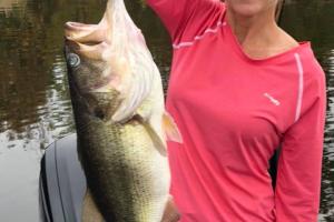 Lady angler is proud holing her 8 pound bass