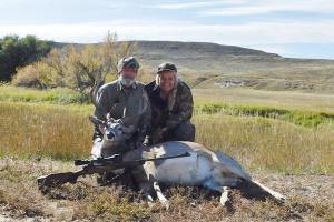 Hunter with mule deer he shot