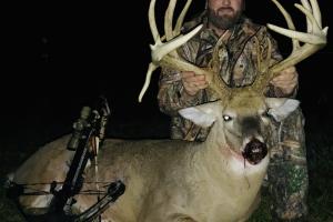 Large buck deer and hunter during bow hunting season