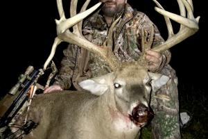 Proud hunter posing behind his large buck trouphy