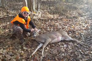 Young deer hunter with his whitetail