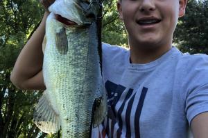 Lunker bass being held by teenaged hunter