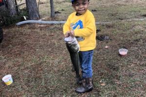 Boy angler holding fish