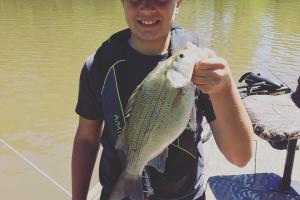 Young boy stripe bass fishing