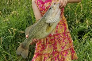 Young girl holding a big bass