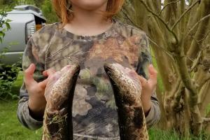 Young girl is a proud angler with two fish