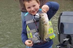 Boy holding up a cold-weather bass