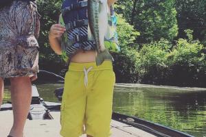 Young angler proudly holding up his bass