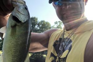 Angler holding his bass fish by the lip