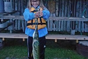 Girl angler standing with the fish she caught 