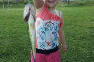Hannah's First Catch. She's holding a bass