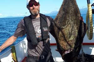 Angler standing next to his southern halibut 