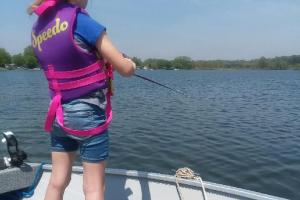 Girl angler fishing from a boat