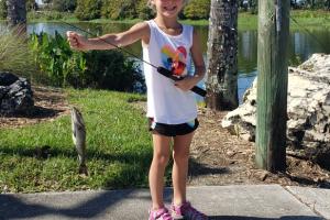 Young girl with her fish at Kids Fishing Ft. Myers Bass Pro