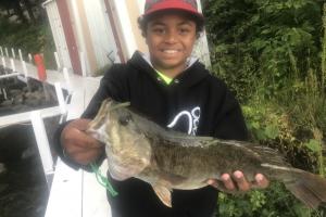 Young bass angler holding a largemouth bass