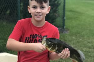 Young boy holding a black bass