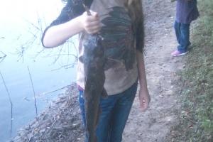 Young girl holding her first catfish