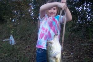 young girl angler holding up a 6 lb bass