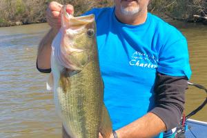 Angler holding  a 9 lb Largemouth Bass