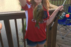 Young girl holding her bluegill fish