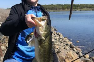 Young angler holding a largemouth bass