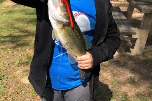 Young angler with bass