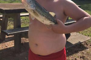 Boy angler holding a mid-size bass