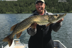 Angler on cover of Hooked magazine holding Pike