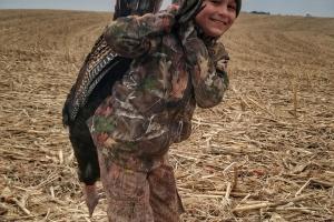 Young turkey hunter in harvested field