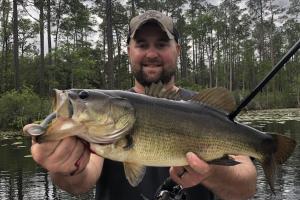 Angler holding largemouth bass