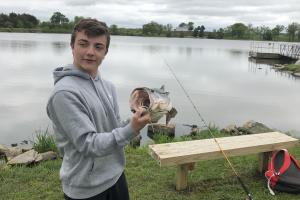 Young angler howing the bass' big mouth