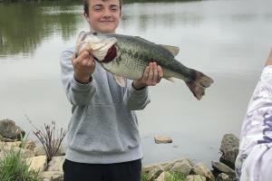 Young angler holding a largemouth bass