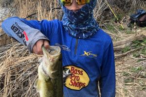 Boy angler holding a mid-size bass