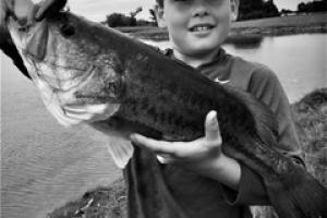Young angler with a largemouth bass