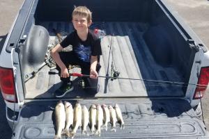 Young angler with his catch of fish