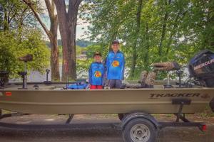 Boys standing in a small fishing boat