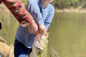 Young angler holding his first bass