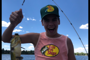 Young angler holding up fish