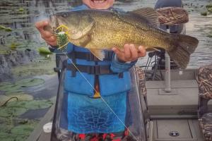 Young boy holding a bass
