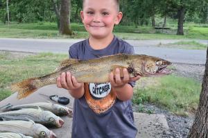 Young angler hold trout