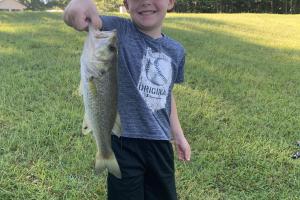 Young angler with a largemouth bass