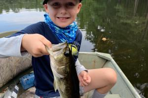 Boy holding pond bass